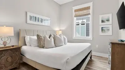 a bedroom with a large white bed and a window at Arcade Bar Prominence Resort Pool and Gym Access Close to Beach Sea Happy in Watersound Beach