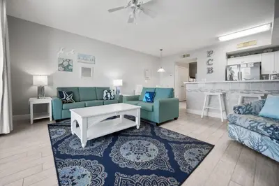 a living room with a couch and a table at Celadon Beach 2107 in Panama City Beach