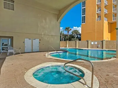 a swimming pool with a hot tub in a building at Celadon Beach 2107 in Panama City Beach
