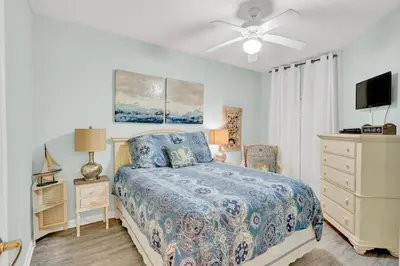 a bedroom with a bed and a ceiling fan at Dunes of Seagrove 106A in Santa Rosa Beach