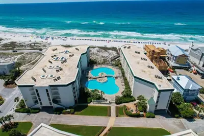 an aerial view of a resort with a pool and the ocean at Dunes of Seagrove 106A in Santa Rosa Beach