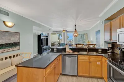 a kitchen with wooden cabinets and a counter top at Dunes of Seagrove 106A in Santa Rosa Beach