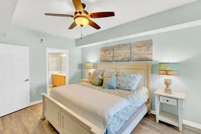 a bedroom with a bed and a ceiling fan at Dunes of Seagrove 106A in Santa Rosa Beach
