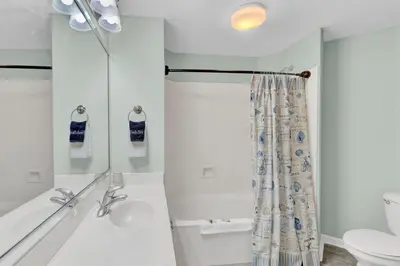 a bathroom with a shower and a sink and a toilet at Dunes of Seagrove 106A in Santa Rosa Beach