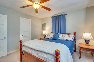 a bedroom with a bed and a ceiling fan at Sunny Panama City Escape with Pool and Deck! in Panama City