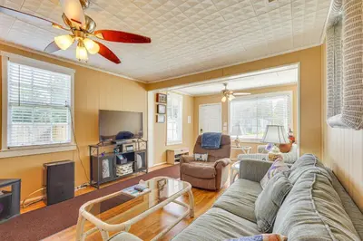 a living room with a couch and a tv at Sunny Panama City Escape with Pool and Deck! in Panama City