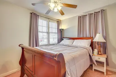 a bedroom with a bed with a ceiling fan and a window at Sunny Panama City Escape with Pool and Deck! in Panama City