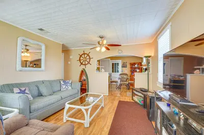 a living room with a couch and a tv at Sunny Panama City Escape with Pool and Deck! in Panama City