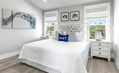 a bedroom with a white bed and two windows at 10 Joanna Sophisticated Seagrove Beach pool sleeps 14 in Santa Rosa Beach