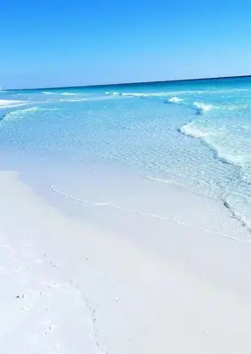 a beach with blue water and white sand and the ocean at 10 Joanna Sophisticated Seagrove Beach pool sleeps 14 in Santa Rosa Beach