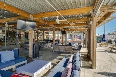 a patio with couches and a television on a roof at Inns at Seacrest 210 in Seacrest