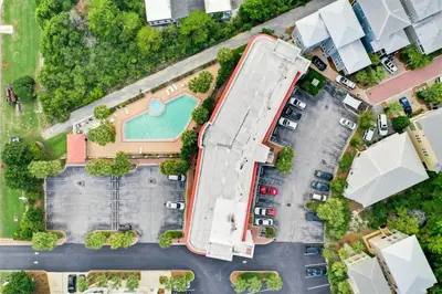an overhead view of a parking lot with a pool at Inns at Seacrest 210 in Seacrest
