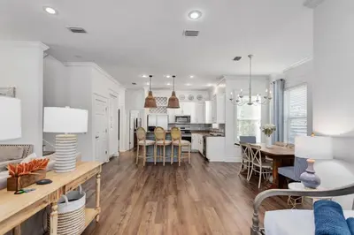 a kitchen and dining room with a table and chairs at Seagrove Retreat - Steps to Beach, Pool, and Seaside in Santa Rosa Beach