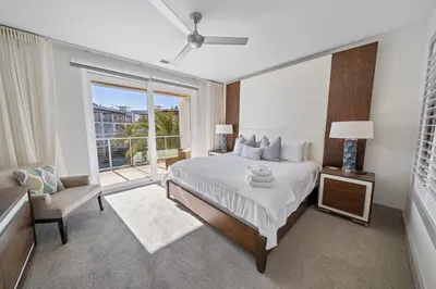 a bedroom with a bed and a large window at The Pointe at Rosemary Beach 332 in Rosemary Beach