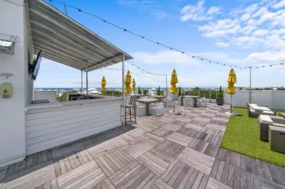 a patio with a bar on the roof of a building at The Pointe at Rosemary Beach 332 in Rosemary Beach