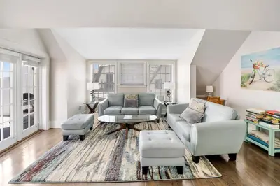 a living room with two couches and a table at Rosemary Beach 5 Main St 1F in Rosemary Beach