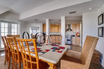 a kitchen and dining room with a table and chairs at Rosemary Beach 5 Main St 1F in Rosemary Beach
