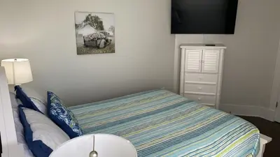 a small bedroom with a bed and a dresser at Rosemary Beach 5 Main St 1F in Rosemary Beach
