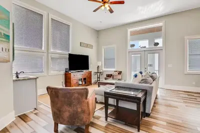 a living room with a couch and a table at Palazzo 30A in Santa Rosa Beach