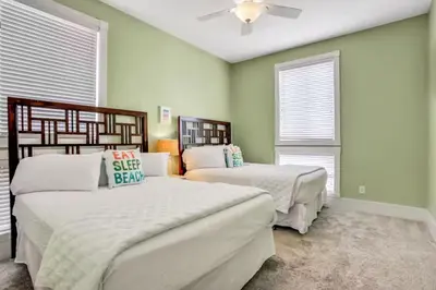 a bedroom with two beds and a ceiling fan at Palazzo 30A in Santa Rosa Beach