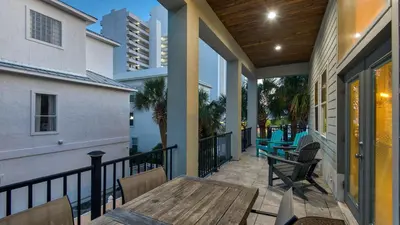 a patio with a table and chairs on a balcony at Palazzo 30A in Santa Rosa Beach