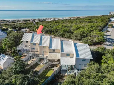 an aerial view of a house with blue and white roofs at Palm Sounds in Inlet Beach