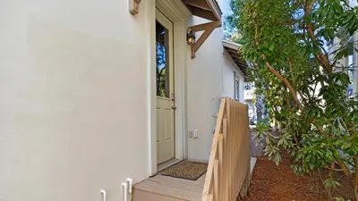 an entrance to a house with a wooden door at 448 Beach Bike Way in Rosemary Beach