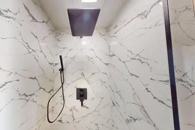 a bathroom with a white marble wall at Treasure Island Unit 905 (2/2) in Panama City Beach