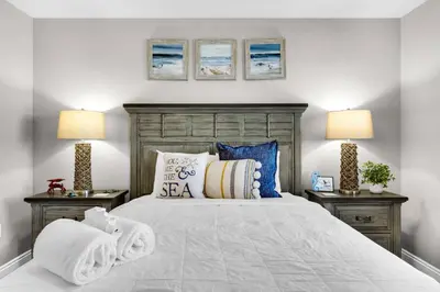 a bedroom with a large bed with two lamps at Treasure Island Unit 905 (2/2) in Panama City Beach