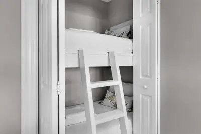 a white bunk bed with a ladder in a room at Treasure Island Unit 905 (2/2) in Panama City Beach