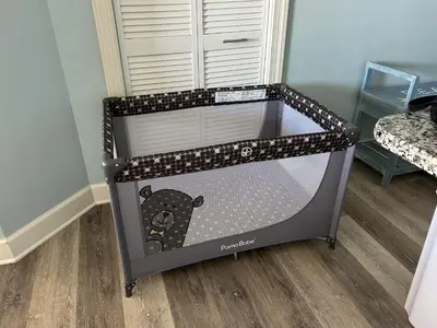 a baby crib with a bear inside of it at Sunrise Beach Condo -Gulf front- free beach chair service in Panama City Beach