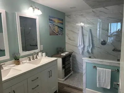 a bathroom with a sink and a shower at Sunrise Beach Condo -Gulf front- free beach chair service in Panama City Beach