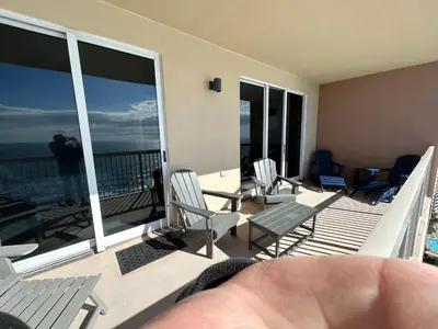 a balcony with chairs and a view of the ocean at Sunrise Beach Condo -Gulf front- free beach chair service in Panama City Beach