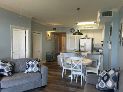 a living room with a couch and a table at Sunrise Beach Condo -Gulf front- free beach chair service in Panama City Beach