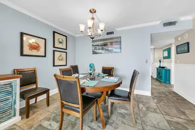 a dining room with a table and chairs at Dunes of Panama 1104E in Panama City Beach