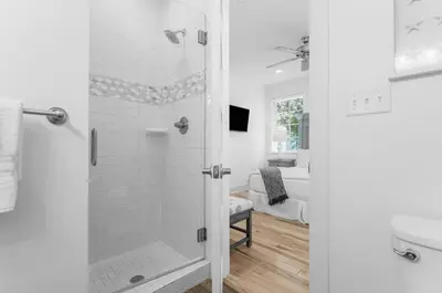 a white bathroom with a shower and a toilet at Available for Season! Hi Beautiful Ciao Bella at Seacrest in Inlet Beach