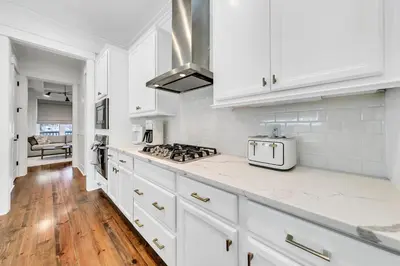 a white kitchen with white cabinets and a stove at Available for Season! After Dune Delight at Nature Walk in Santa Rosa Beach