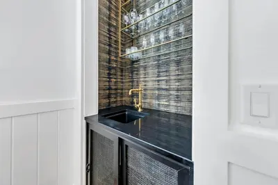 a kitchen with a black counter and a glass door at Available for Season! After Dune Delight at Nature Walk in Santa Rosa Beach