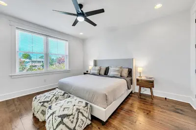 a bedroom with a bed and a ceiling fan at Available for Season! After Dune Delight at Nature Walk in Santa Rosa Beach
