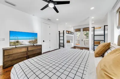 a white bedroom with a bed and a ceiling fan at Available for Season! After Dune Delight at Nature Walk in Santa Rosa Beach