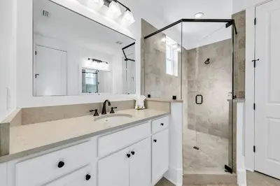 a white bathroom with a sink and a shower at Available for Season! After Dune Delight at Nature Walk in Santa Rosa Beach
