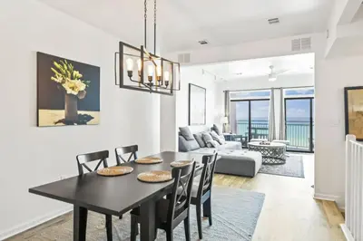 a dining room and living room with a table and chairs at Available for Season! One Life One Love Gulf-Front Townhome in Seagrove Beach