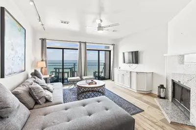 a living room with a couch and a fireplace at Available for Season! One Life One Love Gulf-Front Townhome in Seagrove Beach