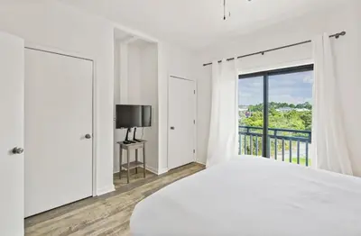 a white bedroom with a bed and a window at Available for Season! One Life One Love Gulf-Front Townhome in Seagrove Beach
