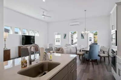 a kitchen with a sink and a living room at The Richest Peasant at Inlet Beach in Inlet Beach
