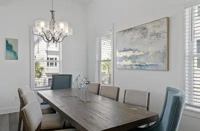a dining room with a wooden table and chairs at The Richest Peasant at Inlet Beach in Inlet Beach