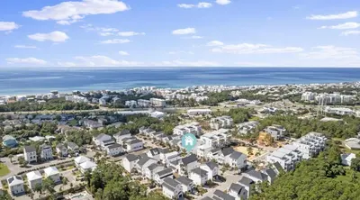 an aerial view of a city and the ocean at The Richest Peasant at Inlet Beach in Inlet Beach