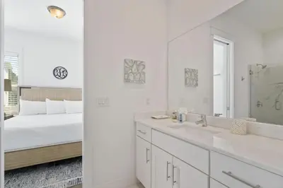 a white bathroom with a bed and a mirror at The Richest Peasant at Inlet Beach in Inlet Beach