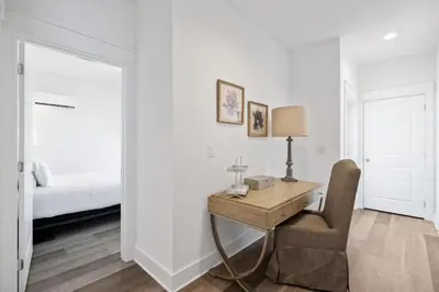 a white room with a desk and a bed at The Richest Peasant at Inlet Beach in Inlet Beach