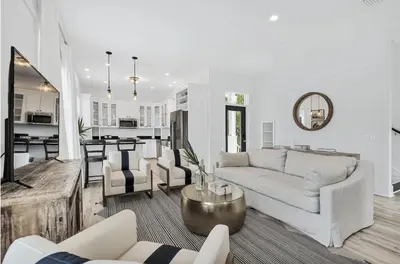 a living room with a couch and a table at Available for Season! Seagrove Harbor 30A - Private Pool in Seagrove Beach